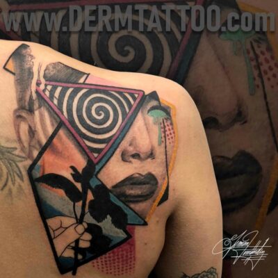 A colorful geometric and abstract tattoo on a shoulder.
