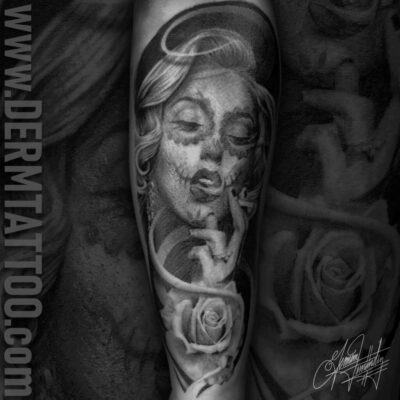 Black and gray tattoo sleeve with a woman's face and floral elements.