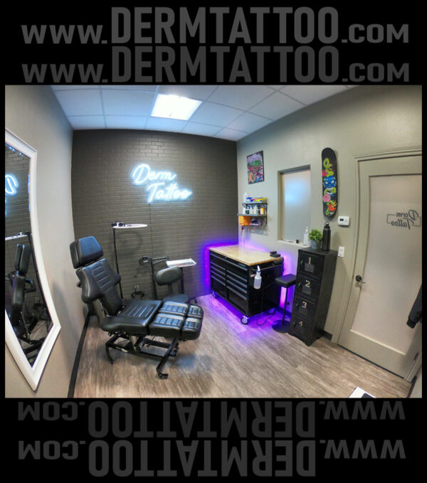 A modern tattoo studio with a chair and illuminated counter.