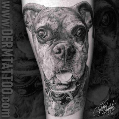 Black and gray tattoo of a dog's face on a person's leg.