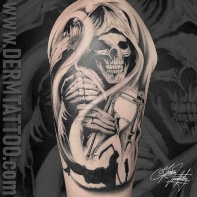 Black and gray tattoo of a grim reaper on an arm.