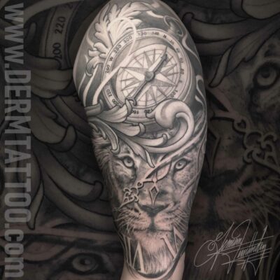 Detailed black and gray tattoo sleeve with fierce lion and ornamental designs.