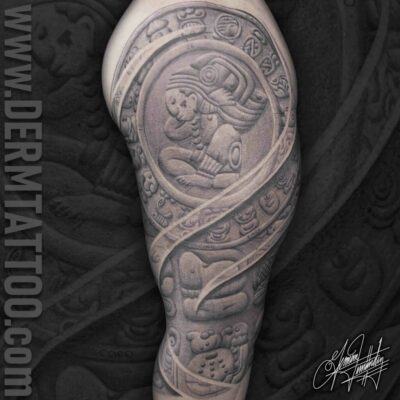 Intricate black and grey tattoo sleeve featuring a detailed warrior helmet and ornamental patterns.