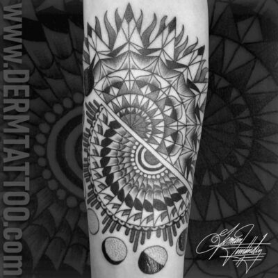 Black and white geometric tattoo with celestial and mandala elements.